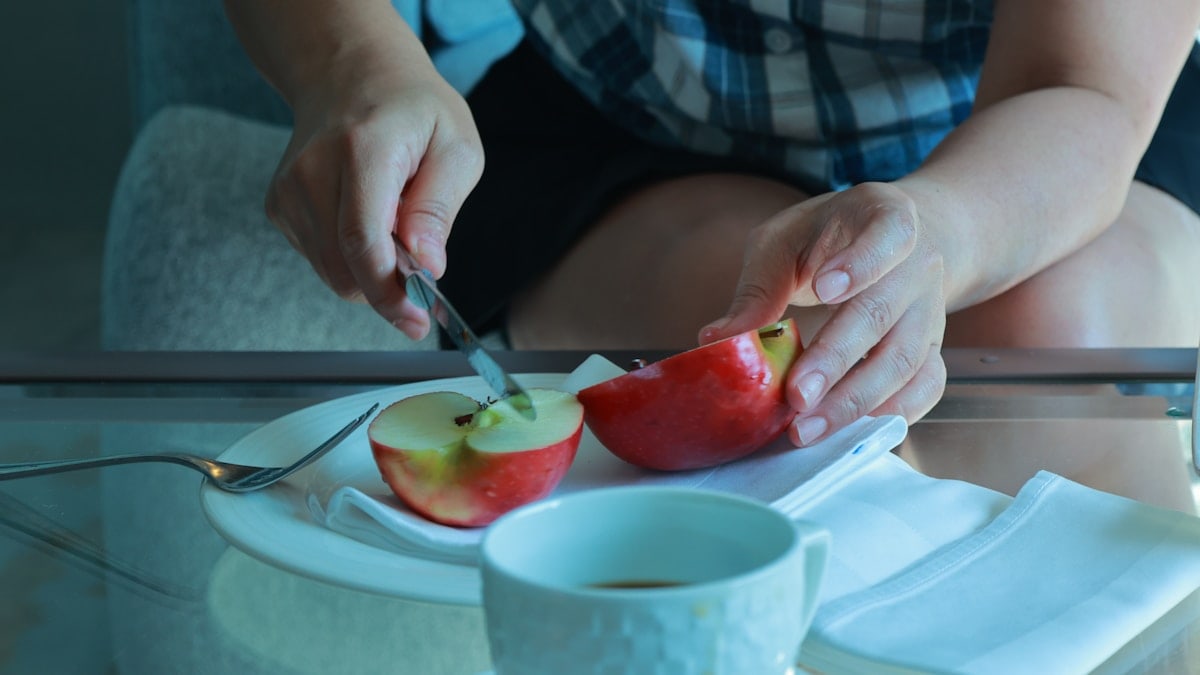 a person cutting a fruit